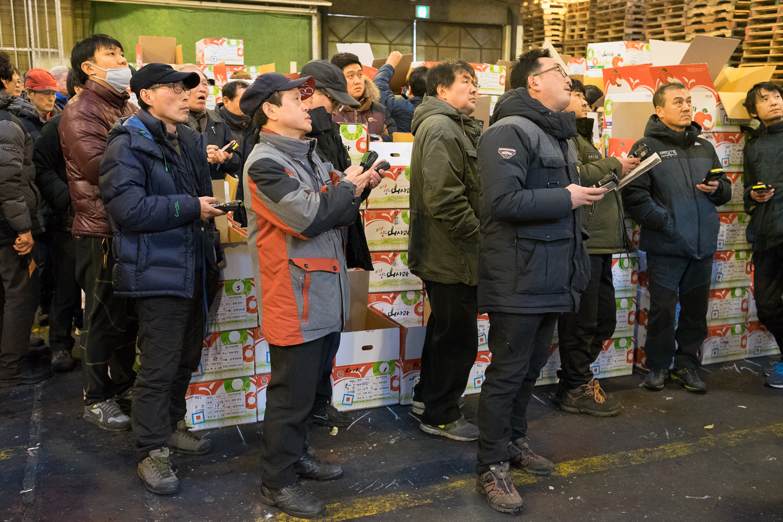 Bidders follow a fruit auction in Garak market